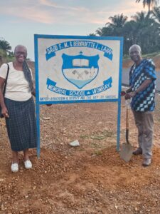 A man and woman standing next to a sign